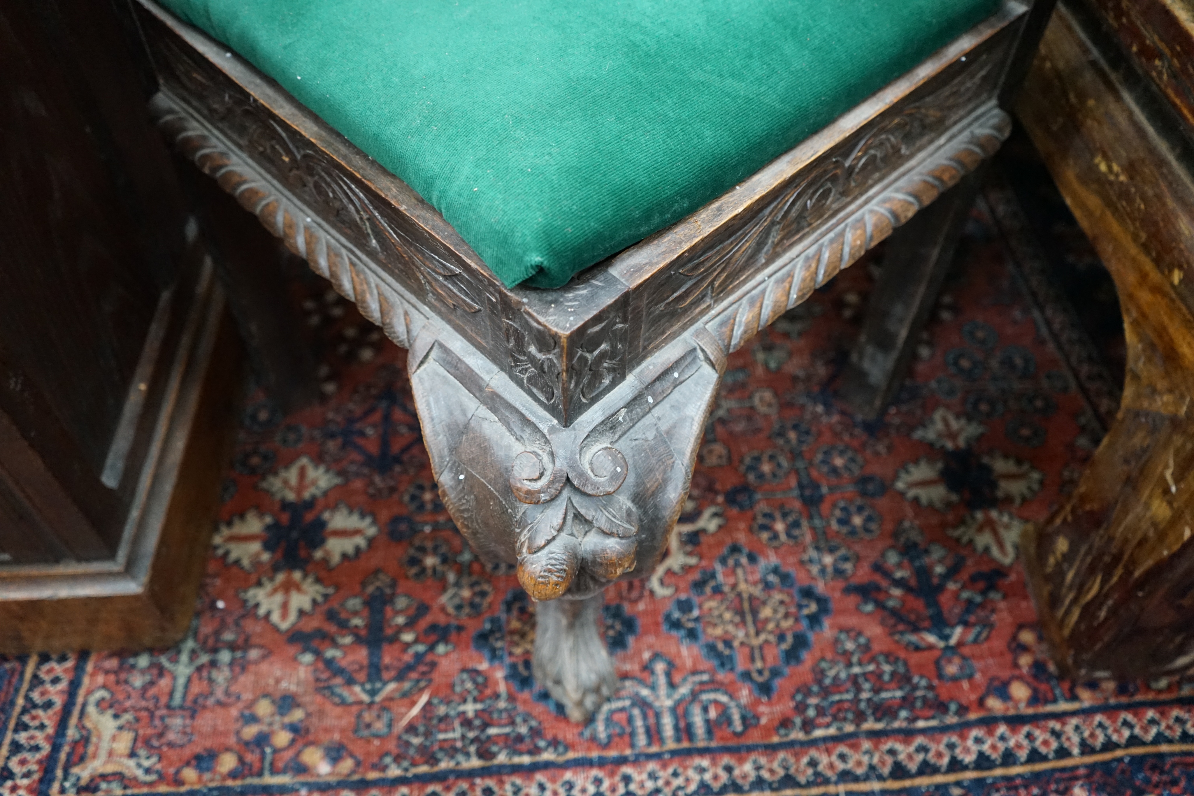 A Victorian carved oak corner elbow chair